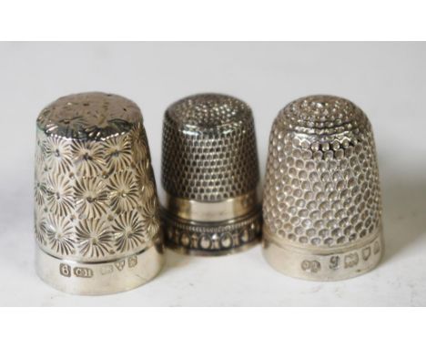 Three Sterling silver sewing thimbles both with English hallmarks,  together with a silver plate thimbles