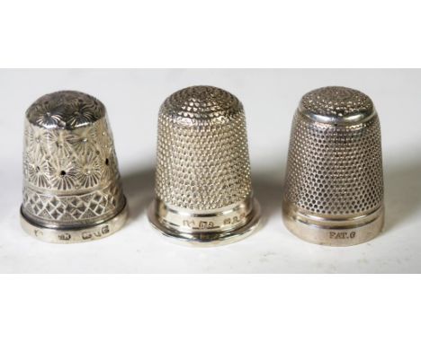 Two Sterling silver sewing thimbles both with English hallmarks, together with a silver plate thimbles