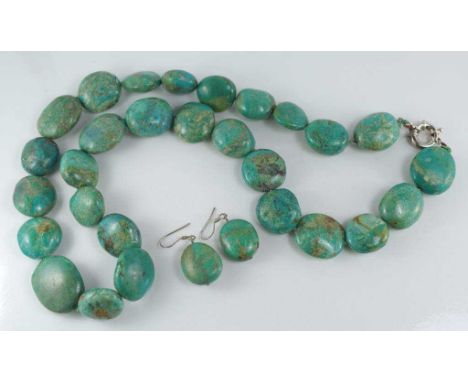 A knotted strand of turquoise beads with silver bolt clasp, approx 66cm long, together with matching earrings