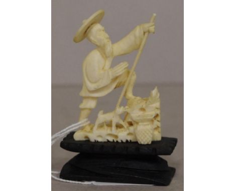 Vintage Chinese carved ivory figure standing man with dog at foot, on wood stand. Export of this item would be subject to CIT