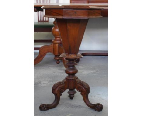 Victorian walnut sewing work table with octagonal inlaid top opening to a fitted interior supported by a carved tripod base, 