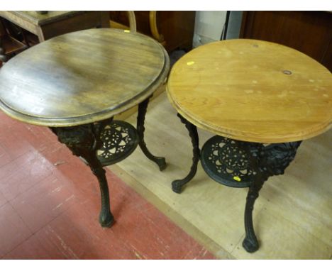 TWO VICTORIAN CAST IRON TAVERN TABLES by Gaskell & Chambers Ltd, Bar Fitters, circular wooden tops with moulded edge, mask de