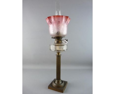 A DUPLEX VICTORIAN OIL LAMP on a brass square base and reeded column, facet cut glass font, brass fittings with Duplex marked
