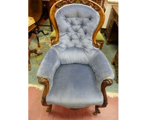A VICTORIAN WALNUT BUTTON BACKED ARMCHAIR, quality carved with pierced top rail, swept arms and shaped knee with knurled foot