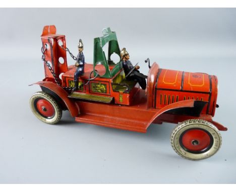 A GUNTHERMANN WIND-UP TINPLATE FIRE ENGINE, well lithographed with two firemen, an SG cord A-13-112 balloon tyres, SG maker's