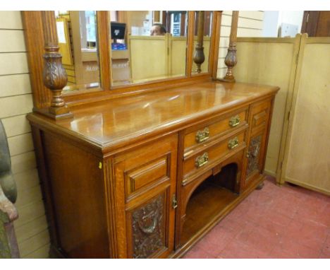 A CIRCA 1900 OAK MIRRORBACK SIDEBOARD with inverted block moulded cornice canopy on acanthus carved and reeded supports with 