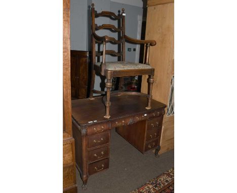 A Mahogany Kneehole Desk, with gadrooned rectangular top and on ball and claw supports, together with an oak ladder back armc