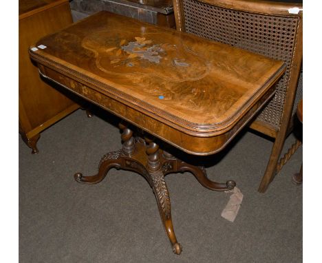 A Victorian Marquetry Inlaid Flame Mahogany Fold Over Card Table, on four barley twist columns, with acanthus carved outswept