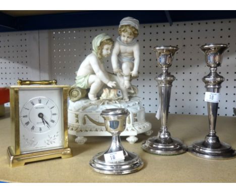 A box set of vintage nursery teawares, three silver candlesticks, modern carriage clock and porcelain figure.