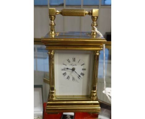 A French carriage clock and key, the dial marked 'Angelus', height 11cm, handle up.