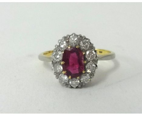 An 18ct ruby and diamond cluster ring, finger size M.