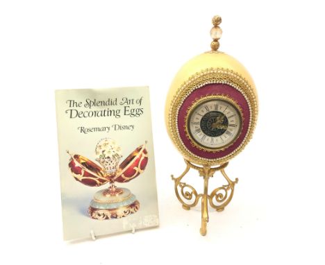 Ostrich egg mantle clock with beaded and gilt thread embellishment, on scroll triform base with 'Mercedes' quartz movement H3