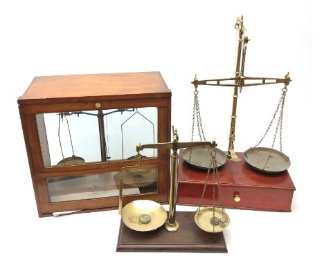 W&T Avery brass balance scale on mahogany base with single drawer, another set of balance scales with weights and a cased set