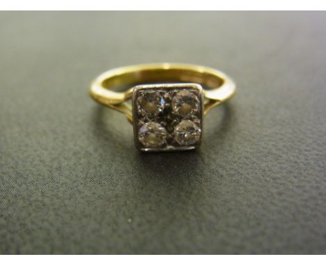 A diamond panel ring - Designed as four brilliant-cut diamonds to the bifurcated shoulders and plain band - Estimated total d