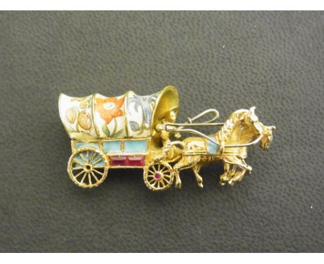 A continental gold ruby and enamel brooch - Designed as two horses pulling a gypsy caravan - Stamped 750 - Length 4.3cms - We