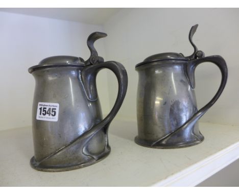 A pair of pewter Tudric Archibold Knox lidded tankards - Height 18cm
Condition report:  Both overall sound but various dents 