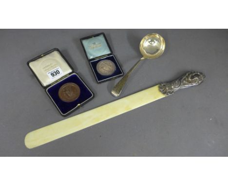 A silver ladle London 800 maker R C, a silver medallion, another medallion and a white metal handle page turner - Total appro