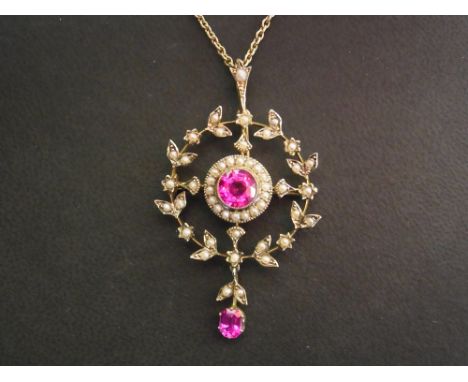 A synthetic ruby and seed pearl foliate drop pendant - Suspended from a fancy-link chain - Tests as 9ct gold with a higher ca