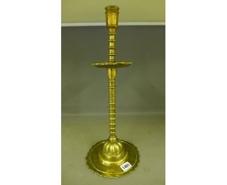 An early brass Altar candlestick with ring turned stem and florette chased base - Height 44 cm 
Condition report:  Wear and r
