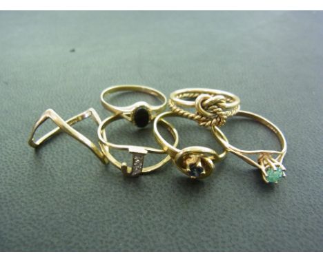 A collection of six 9 ct gold dress rings, one set with diamonds, one emerald, one sapphire, one black onyx - Total approx. w