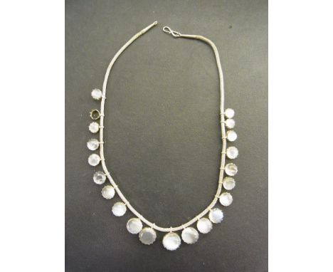 A moonstone cabochon graduated necklace - To the white metal woven chain - Length 36cms - Weight approx 15.6gms
Condition Rep