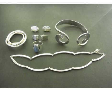 An assortment of jewellery - To include a bangle, two pairs of earrings, a ring, a necklace and a brooch - All with marks ind