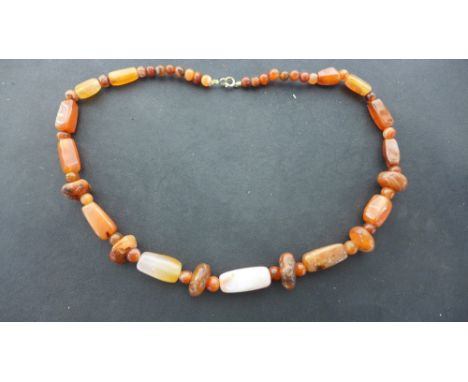 An Ancient carved Carnelian bead necklace 
Condition report:  Re-strung, no further condition report on this item