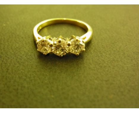 A brilliant-cut diamond three-stone ring - Total diamond weight 1ct, stamped to band - Stamped 18K - Ring size K 1/2 - Weight