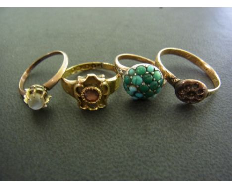 A collection of four antique gold rings including an 18 ct Victorian mourning ring set with a ruby inscription dated 1862, a 