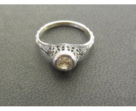 A diamond single-stone ring - The brilliant-cut diamond within a collet setting with pierced decoration to the plain band - E