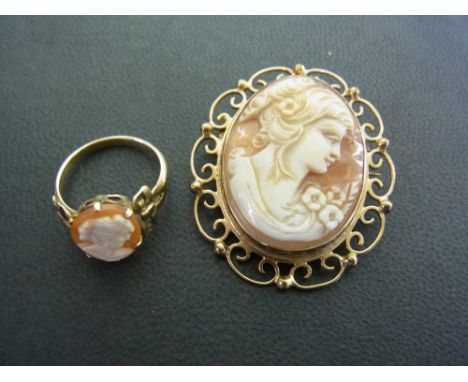 A 9 ct gold mounted cameo brooch with an ornate surround and a 9 ct gold cameo ring -   size M - the shoulders in the form of