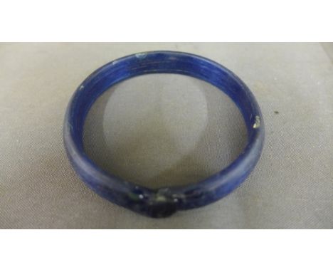 An Ancient Roman blue glass bangle 2 nd AD - Diameter 7.5 cm
Condition report:  This is an Antique item so has normal wear or