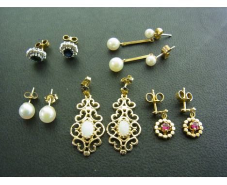 Five pairs of gold earring to include opal and 9 ct pendants, 9 ct and ruby drops, 9 ct white gold sapphire and cz clusters, 