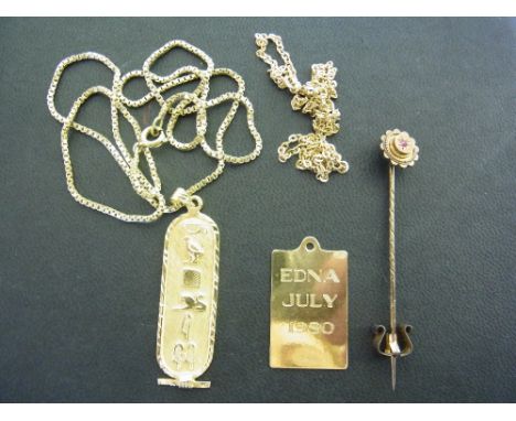 An Egyptian style gold pendant with foreign hallmarks, a gold ingot and two chains - all tested as 18 ct gold - Total weight 