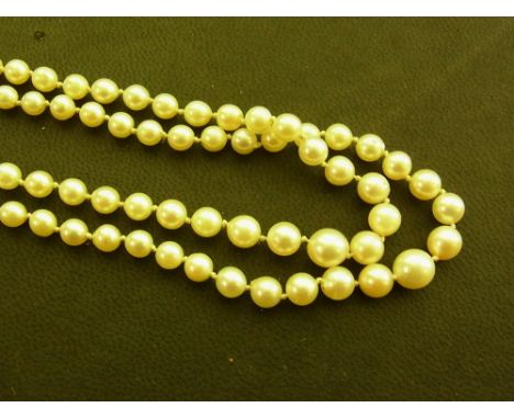 A graduated cultured pearl two-row necklace - Pearls measure approx 4mm - 7mm - To the plain clasp - Length approx 44cms 
Con