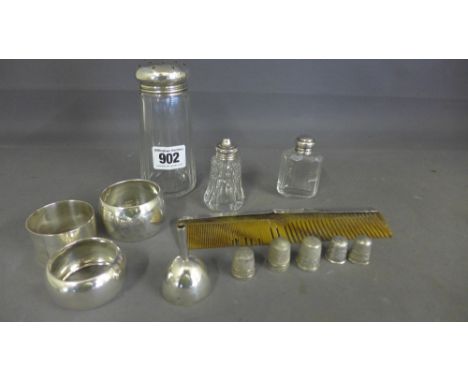 Three silver napkin rings, five silver thimbles, a silver perfume funnel, three silver top bottles and a silver top comb - To