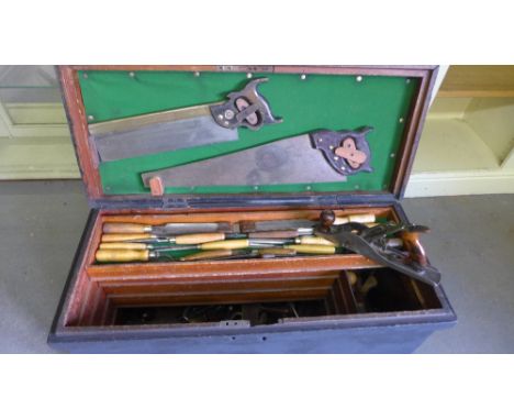 A black painted Carpenters/pattern makers fitted Tool box containing a large amount of chisels, planes and other various tool