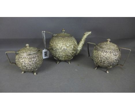 An Indian silver (tested) three piece bachelors tea service, all over embossed decoration depicting birds amidst foliage - To