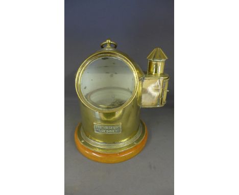 A Reynolds and Son of London brass Binnacle with side oil lamp on a wooden stand - Height 30 cm 
Condition report: Working co