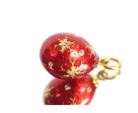 A yellow metal and enamel egg shaped pendant