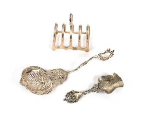 A George V silver toast rack, Birmingham 1926; a Dutch caddy spoon; and a large continental white metal spoon decorated with 