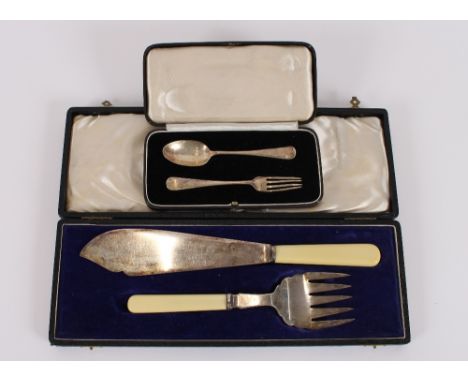 A cased silver Christening set, comprising of a spoon and fork, London 1938; and a pair of plated fish servers by Walker &amp