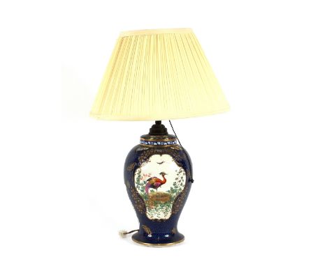 A Booth's silicone china reading lamp, decorated with panels of exotic birds on a Royal blue scaled ground, heightened in gil