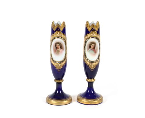 A pair of 19th Century opaque glass spill vases, decorated with oval portrait panels of children on a rich blue ground, heigh