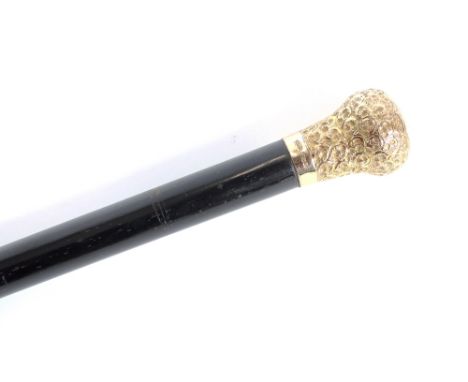 An ebony walking stick, with gold plated foliate knop handle, 92cm long