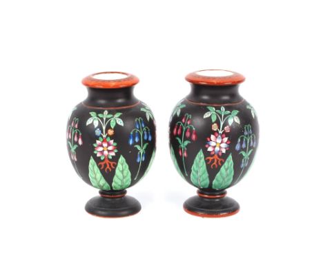 A pair of Prattware baluster vases, profusely decorated with flowers on a black and ochre ground, 15.5cm high