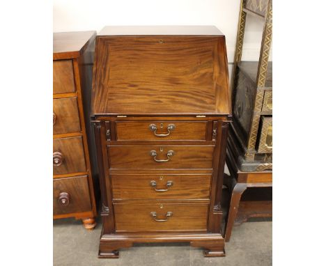 A mahogany bureau, of small proportions, fall front opening to reveal an interior arrangement of drawers and pigeon-holes aro