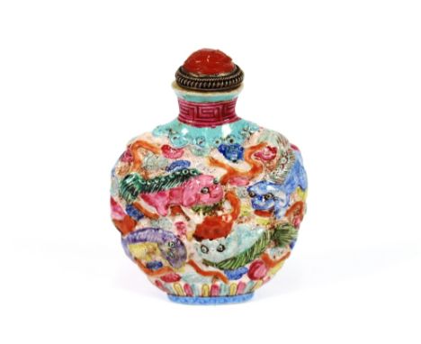 A 19th Century polychrome decorated Chinese moulded porcelain snuff bottle, painted with Shi Shi dogs, four character iron re