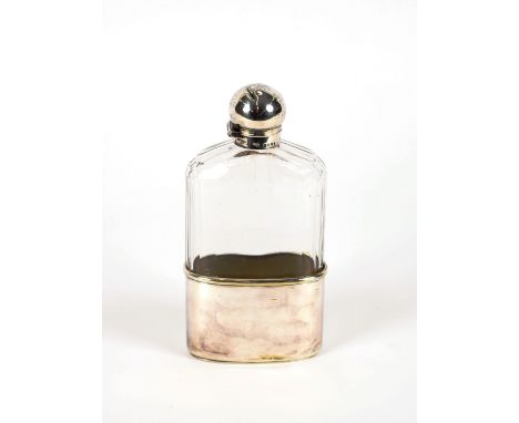 A large faceted glass travelling spirit flask, having silver cap, hallmarked for London 1879, with detachable plated drinking