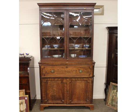 A 19th Century mahogany secretaire bookcase, surmounted by a stepped pediment, the upper adjustable shelves enclosed by a pai